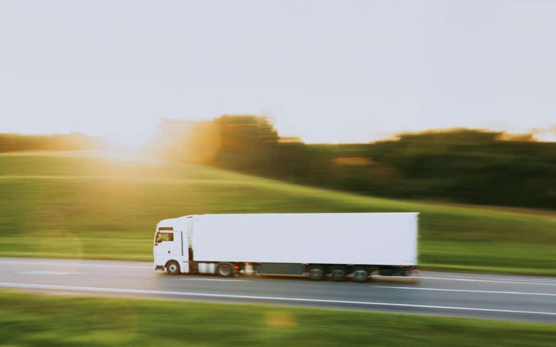 Ein LKW fährt schnell über eine einsame Straße