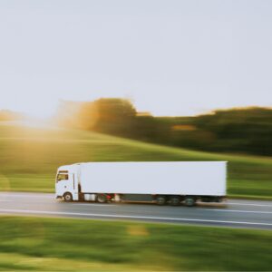 Ein LKW fährt schnell über eine einsame Straße